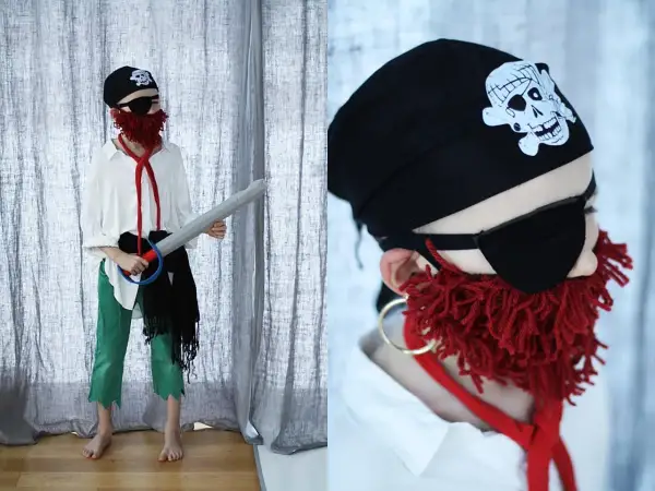 Dziecko w stroju pirata: czarna bandama z czaszką, opaska na oko, czerwona broda z włóczki, biała koszula, zielone spodnie i miecz. Oto jak przebrać dziecko za pirata!